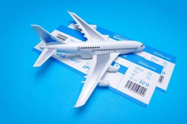 plane-boarding-passes-on-blue-background-travel-holiday-composition-photo